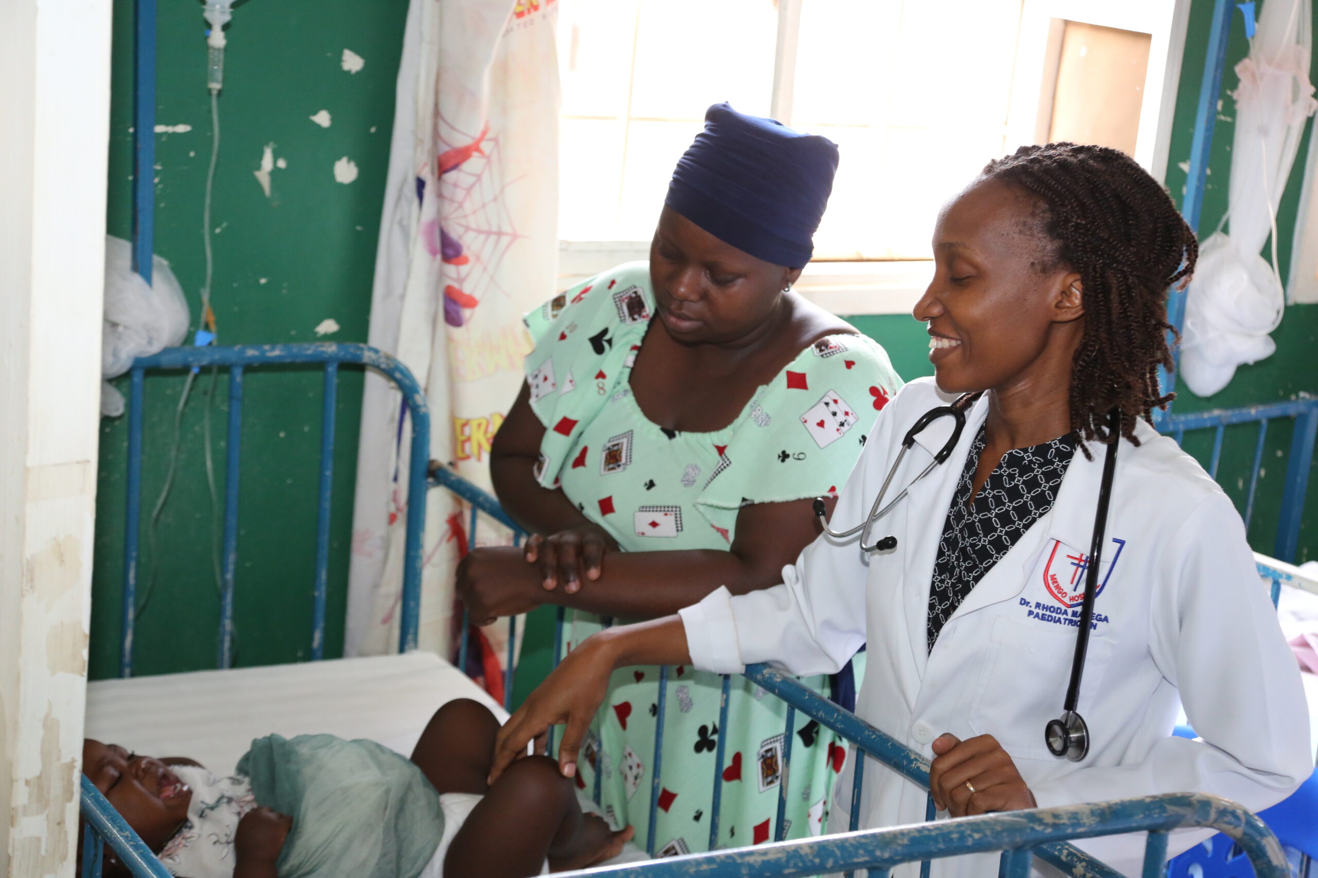 Dr. Rhoda, at right, attends to a patient.