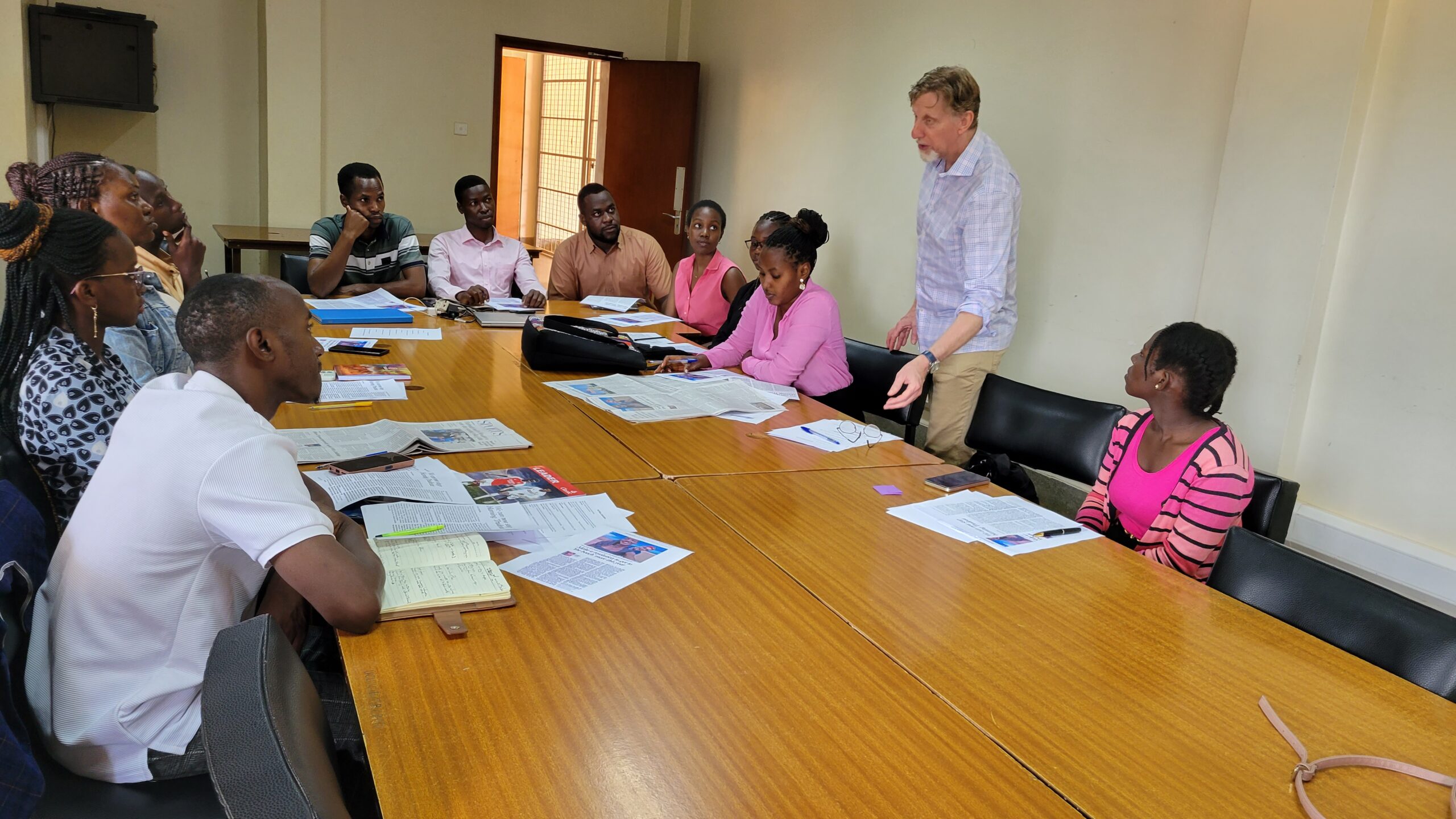 Canadian journalist Thomas Froese interacts with UCU writing center coaches in the Hamu Mukasa Library on January 21, 2025.