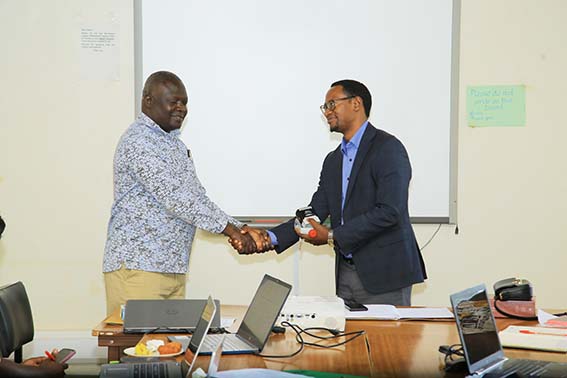 Rev. Assoc. Prof. Andrew David Omona (left) handing over office to Dr. Martin Kizito.