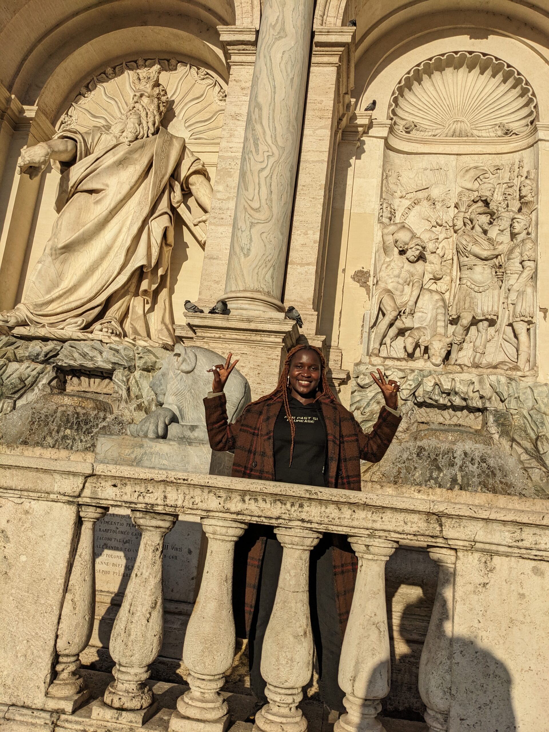 Atim Prisca Enabu, UCU student, poses at the Trevi Fountain, an 18th-century structure in Italy, where Atim is studying this semester.