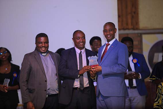 Deo Musekura (center) receives his award from UCU Vice Chancellor Aaron Mushengyezi. At left is Deputy Vice Chancellor for Academic Affairs Assoc. Prof. John Kitayimbwa.