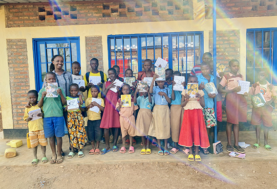 Maureen Mutoni with some of the children aided by her program.