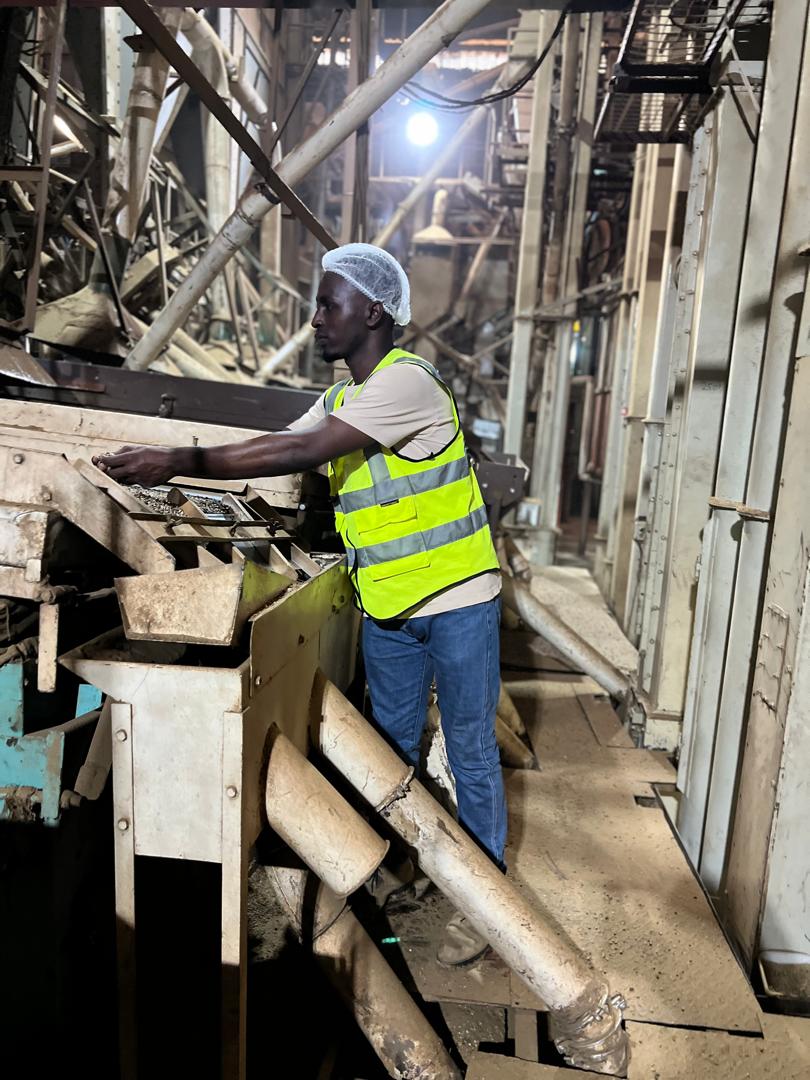 Epaphra attends to beans during production process. (Courtesy Photo)