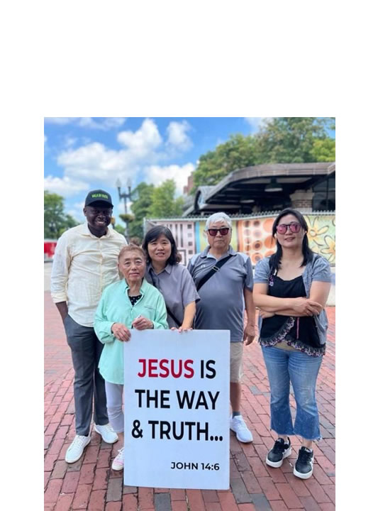 Moses Mukitale with members of his church in Boston