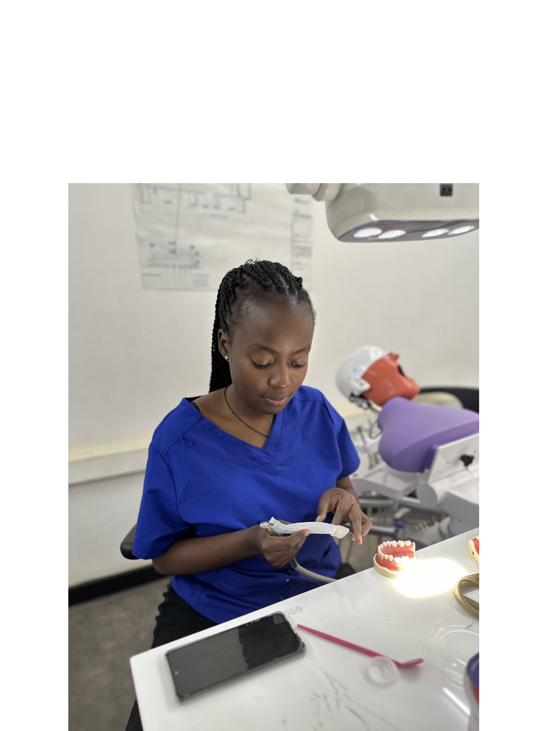 Kamaranzi Ruth Angella while volunteering at the dental clinic