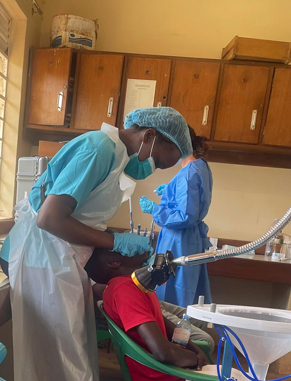 Masaba Esther Loy Anyala, graduate of the UCU School of Dentistry, treats a patient. She is among more than 400 dental specialists in Uganda.