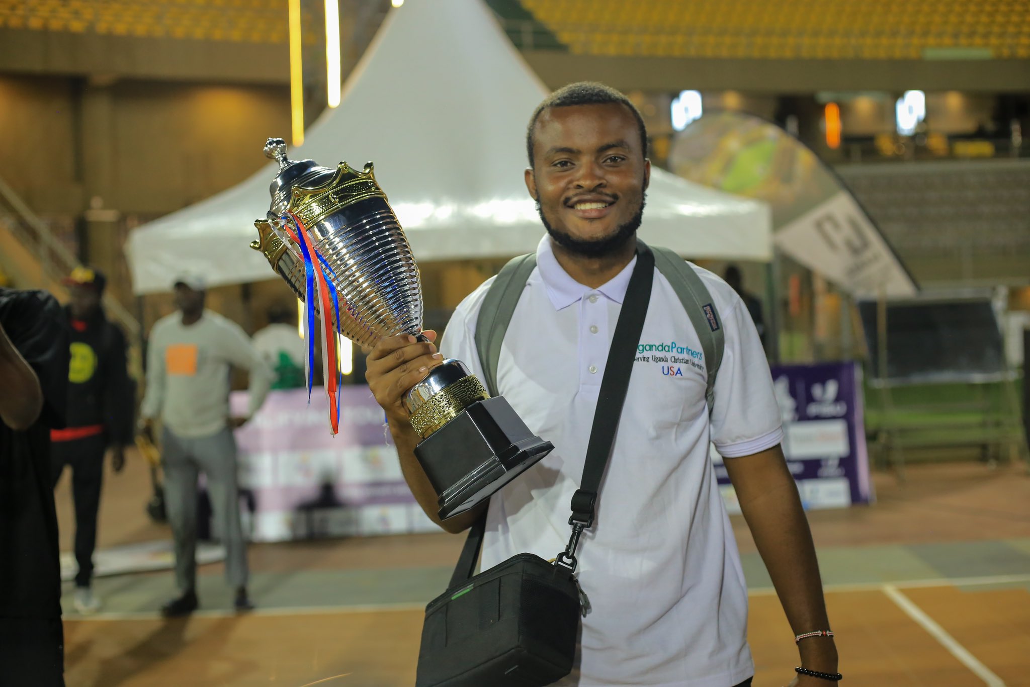 Michael Ainomugisha holds the trophy after the UCU Badminton team emerged victorious in the Federation of African Universities Sports (FASU) Badminton Challenge, held at Makerere University in Kampala.