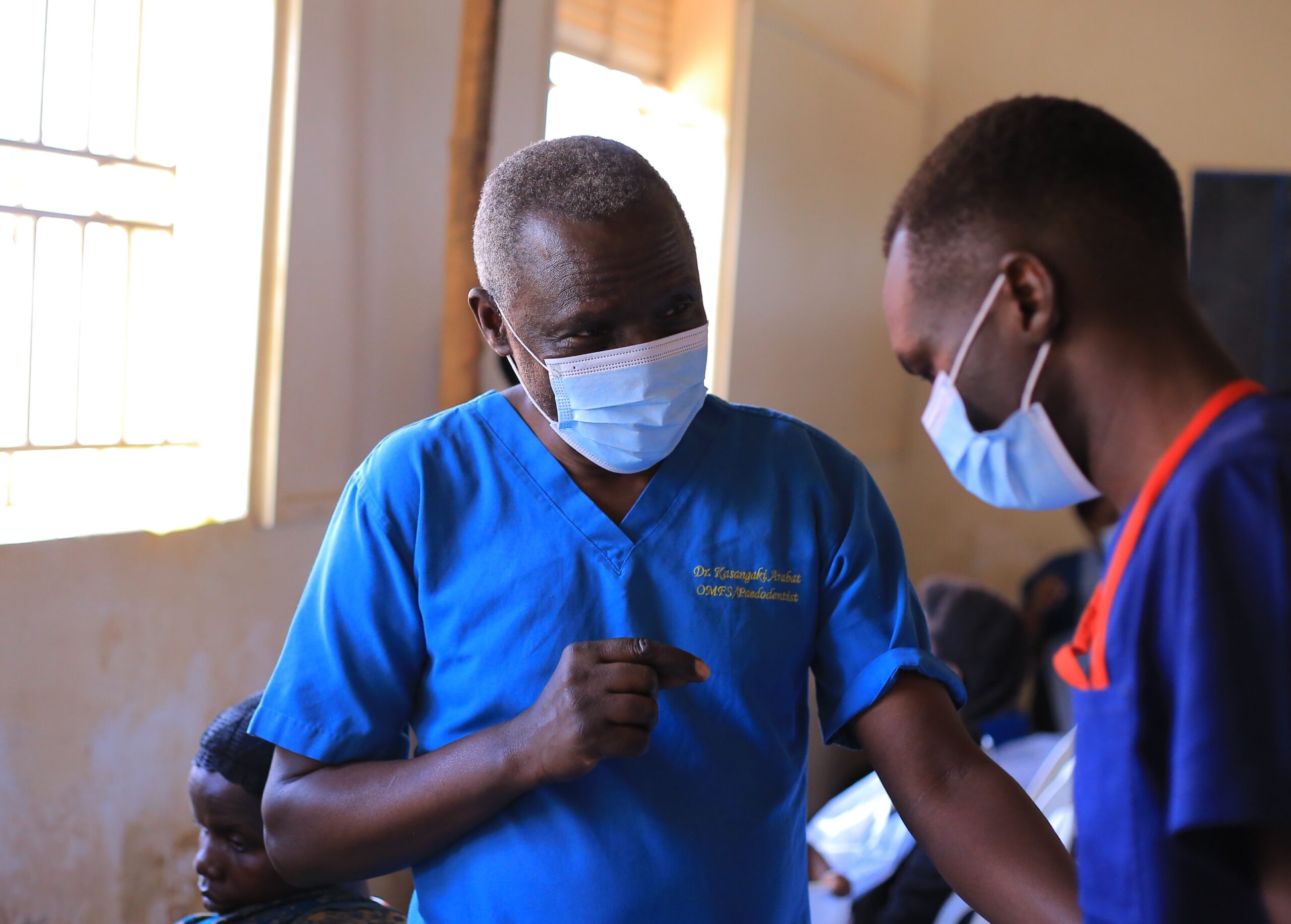 Dr. Kasangaki Arabat guides a student during the UCU outreach in Bombo.