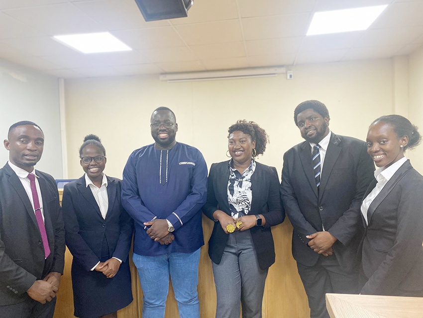 Awor (third-right), with Joel Basoga (third-left), a lecturer in the Faculty of Law, and the Jessup Moot Court winning team