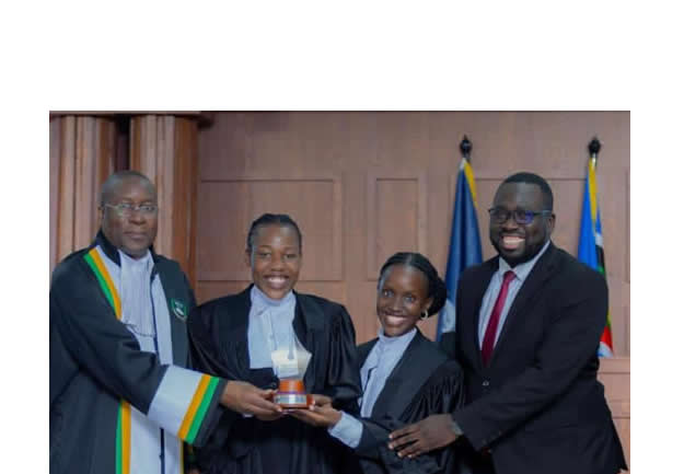 Right to left: UCU moot coordinator and coach, Joel Basoga, with students, Heather Stacy Kutamba and Sandra Ajambo, receive an award from the chief guest, Justice Duncan Gaswaga, a Judge of the African Court on Human and People's Rights and a Judge of the High Court of Uganda.
