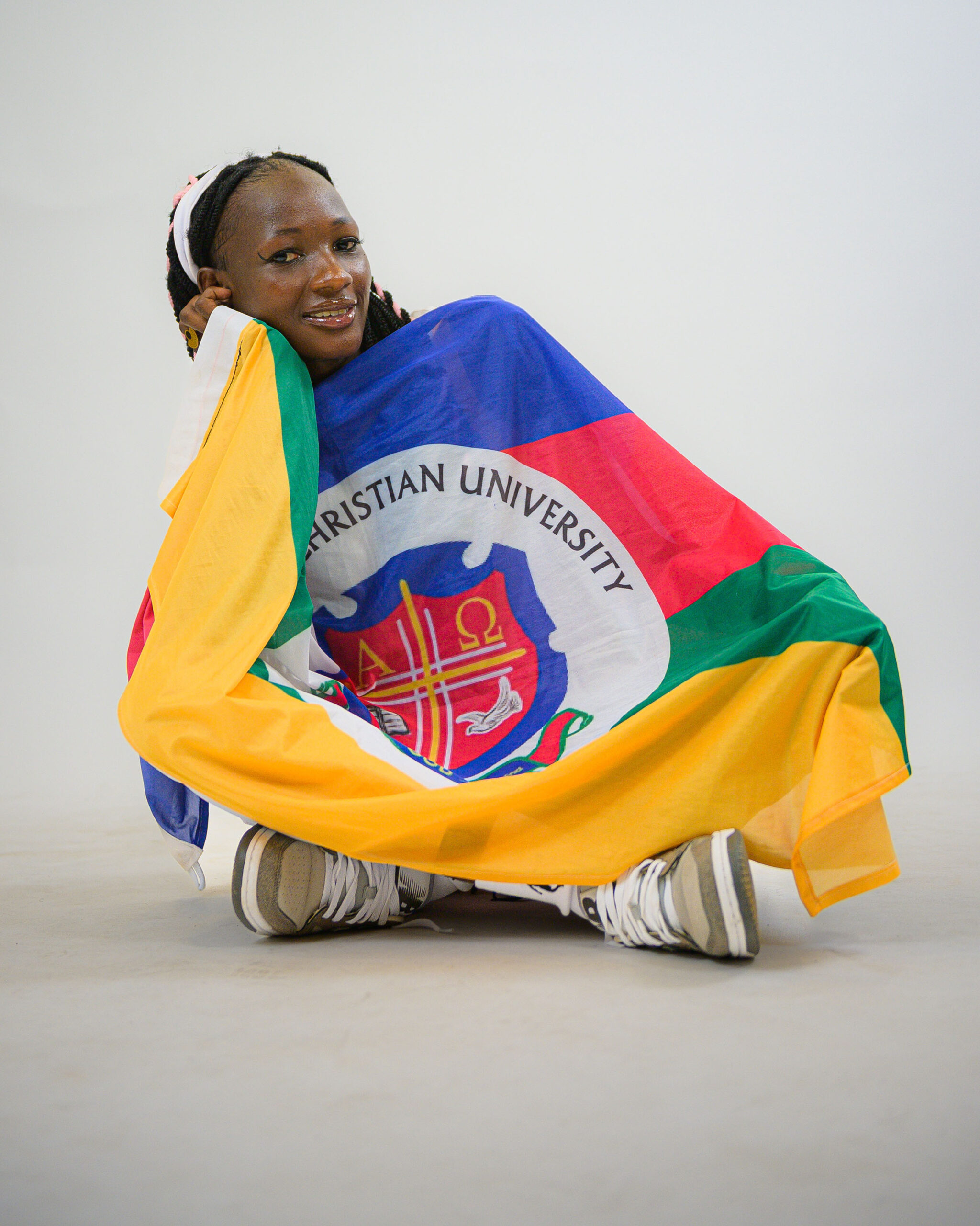 Lady Canons captain Shillah Lamunu proudly holds the UCU flag during the 2025 FISU 3x3 World Cup in Brasília.