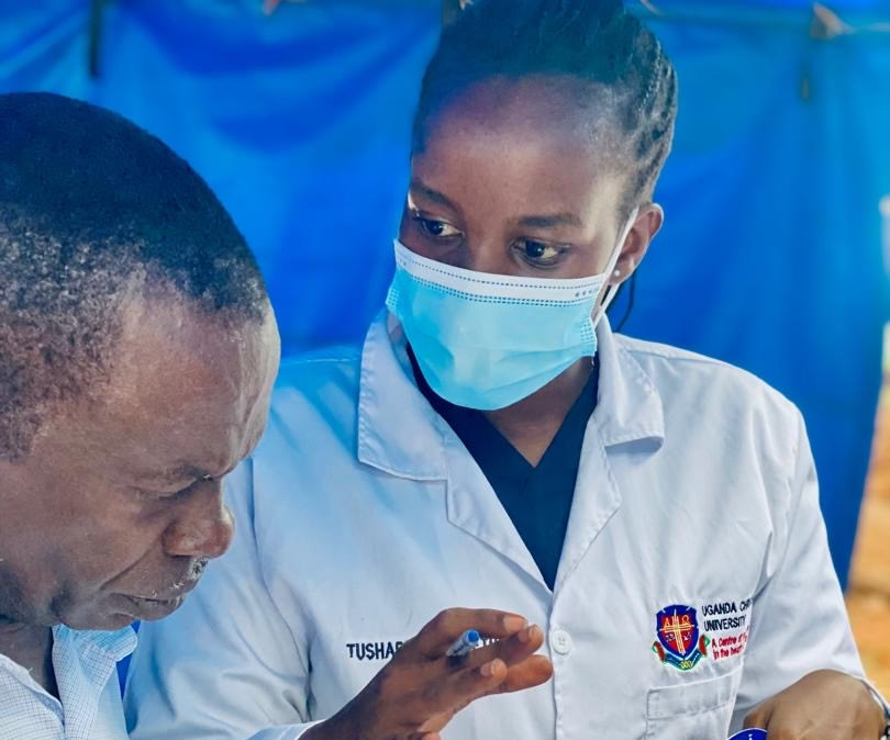 Elizabeth Tushabe engages with one of her lecturers during her time at Uganda Christian University, where her foundation in medicine was shaped.
