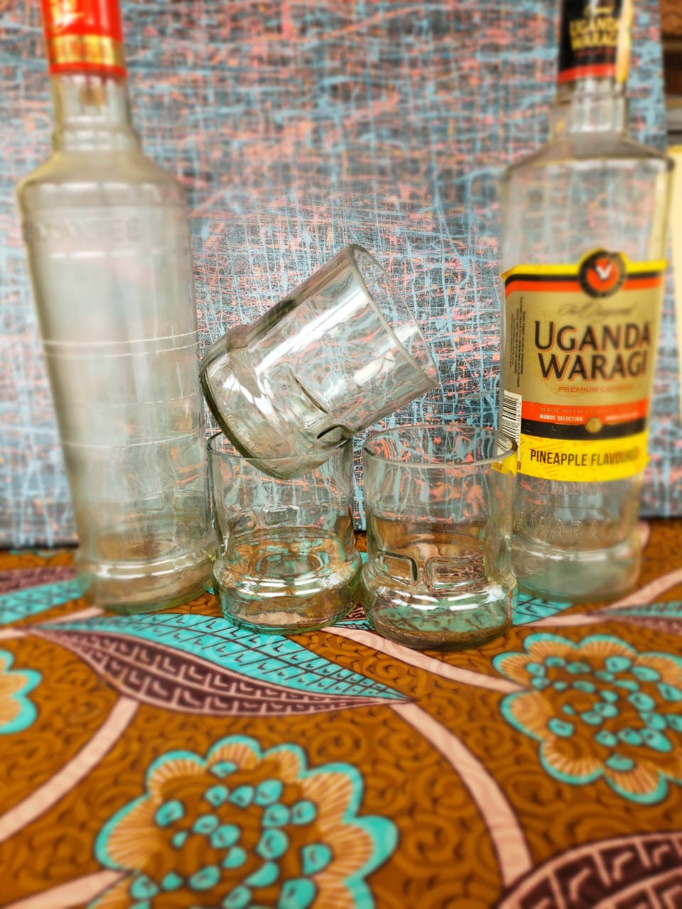 Glasses made from wine bottles that Reagan Okello picked from bars