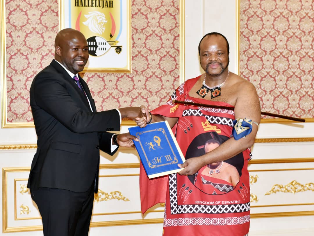 Ambassador Paul Amoru, left, Uganda’s Non-Resident High Commissioner to Eswatini, receives a gift from His Majesty King Mswati III of Eswatini after presenting his Letters of Credence at the Royal Palace.