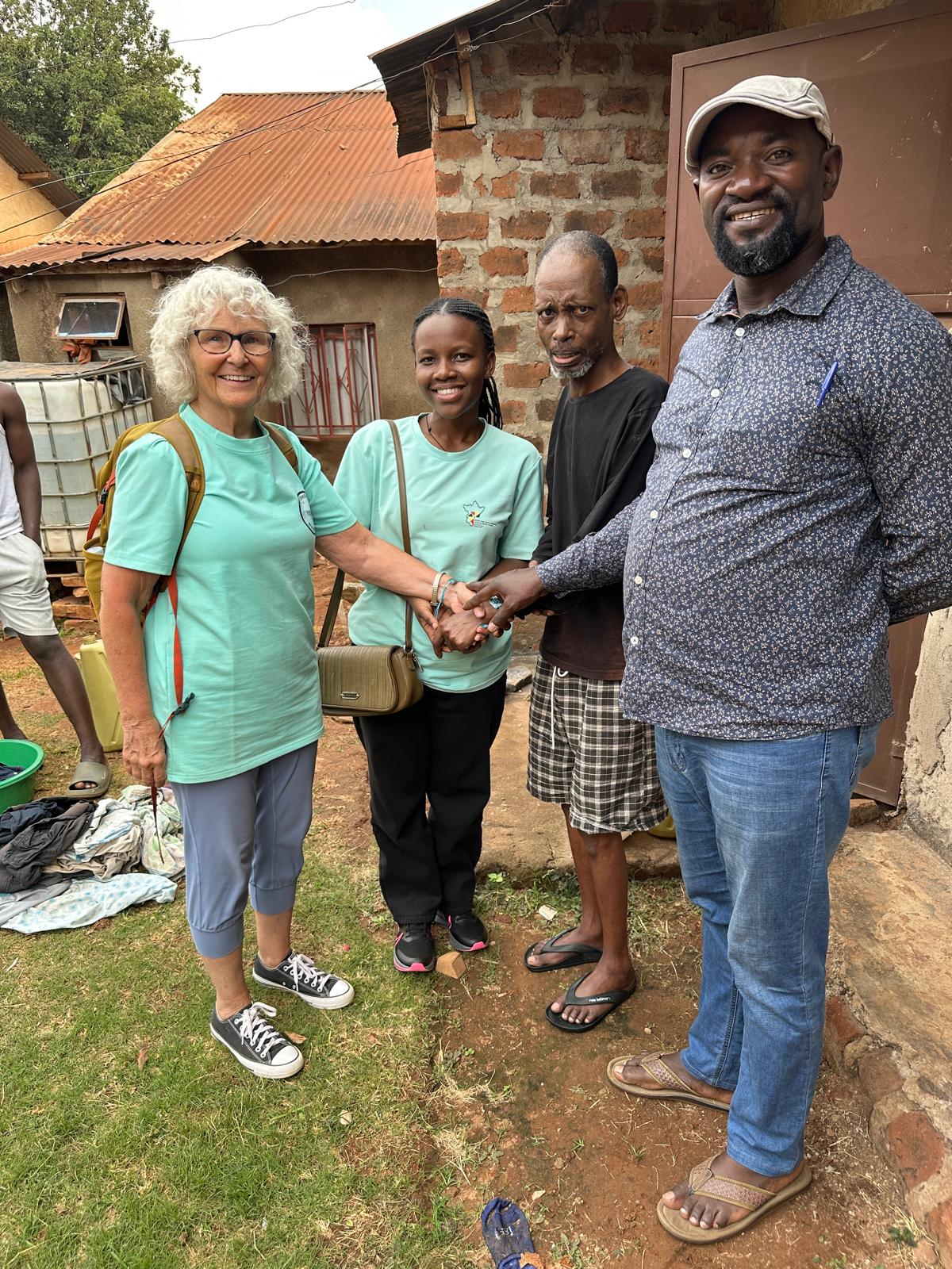 Posing outside a home in Mbuya parish, Kampala, are (left to right) Patty Huston-Holm, Linda Ojore, Patrick Byaruhanga and Hannington Kabugo.