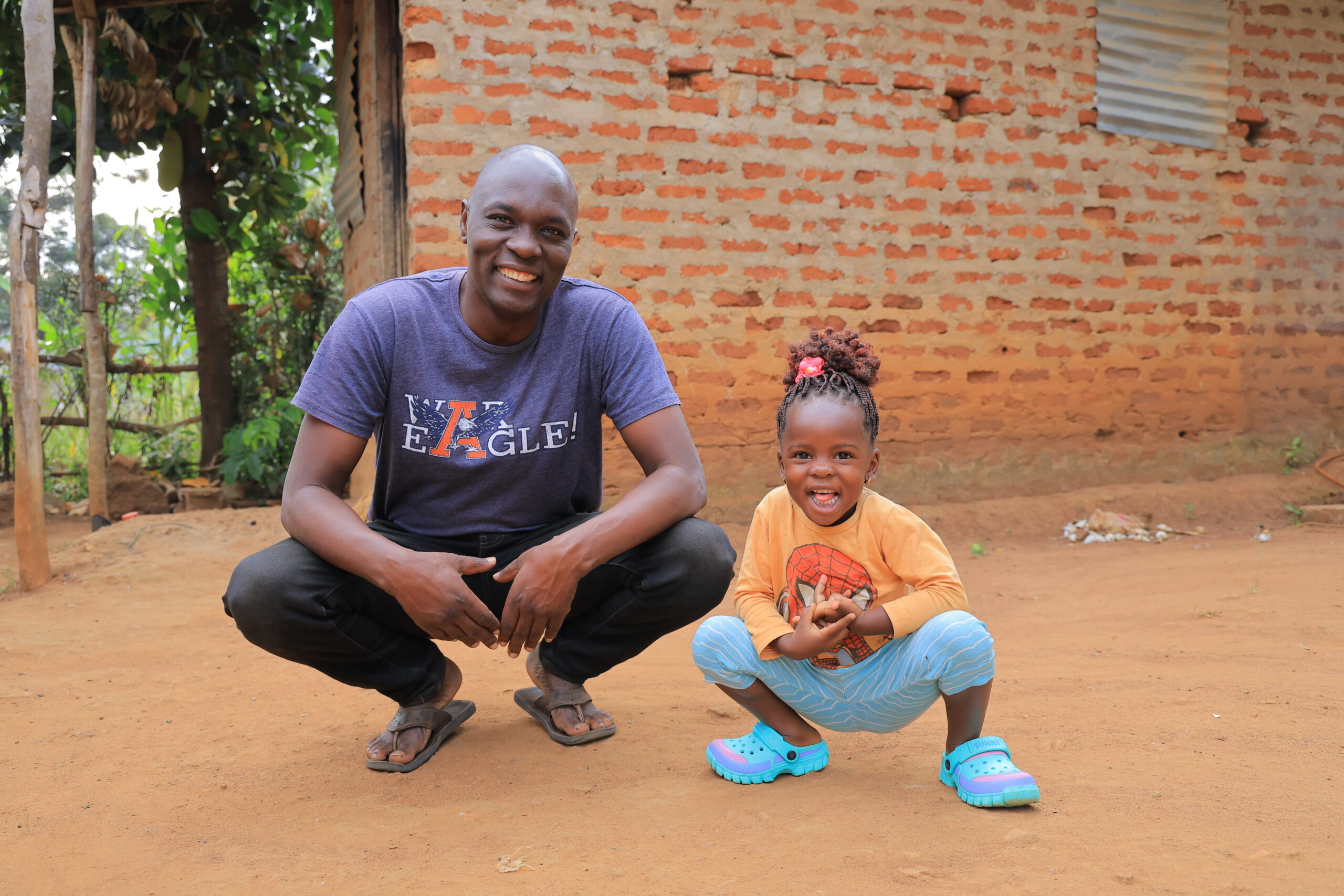 Frank Obonyo with his two-year-old niece, Kimaya Aboth, during a summer 2026 visit to his native Per-Per Village