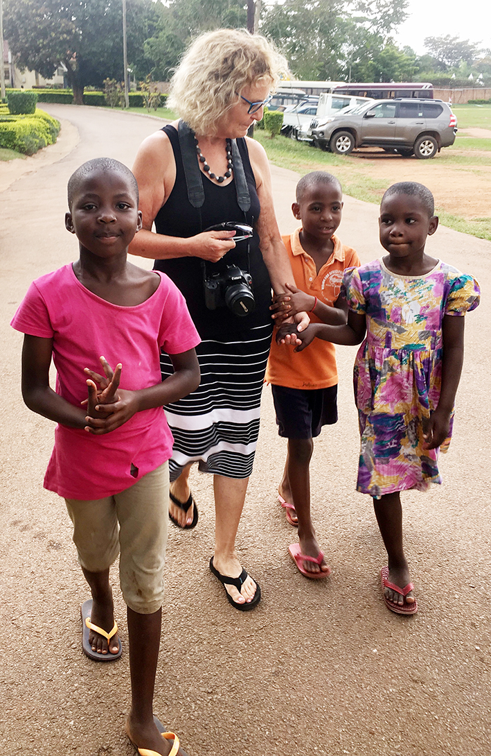 Patty walking with children in African Village, Kiyunga, Mukono District, Uganda, in 2018