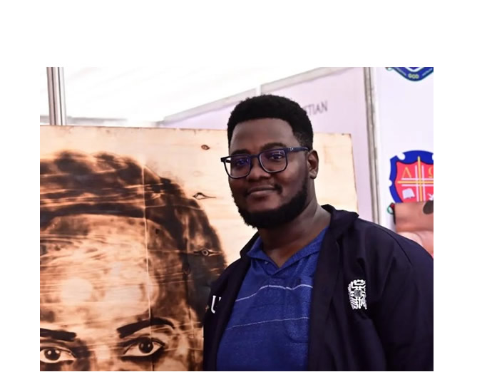 Isaac Rwenzigye with one of his art pieces