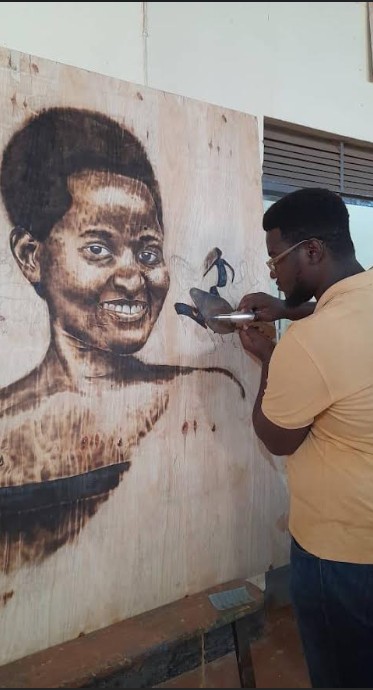 Isaac Rwenzigye working on an art project